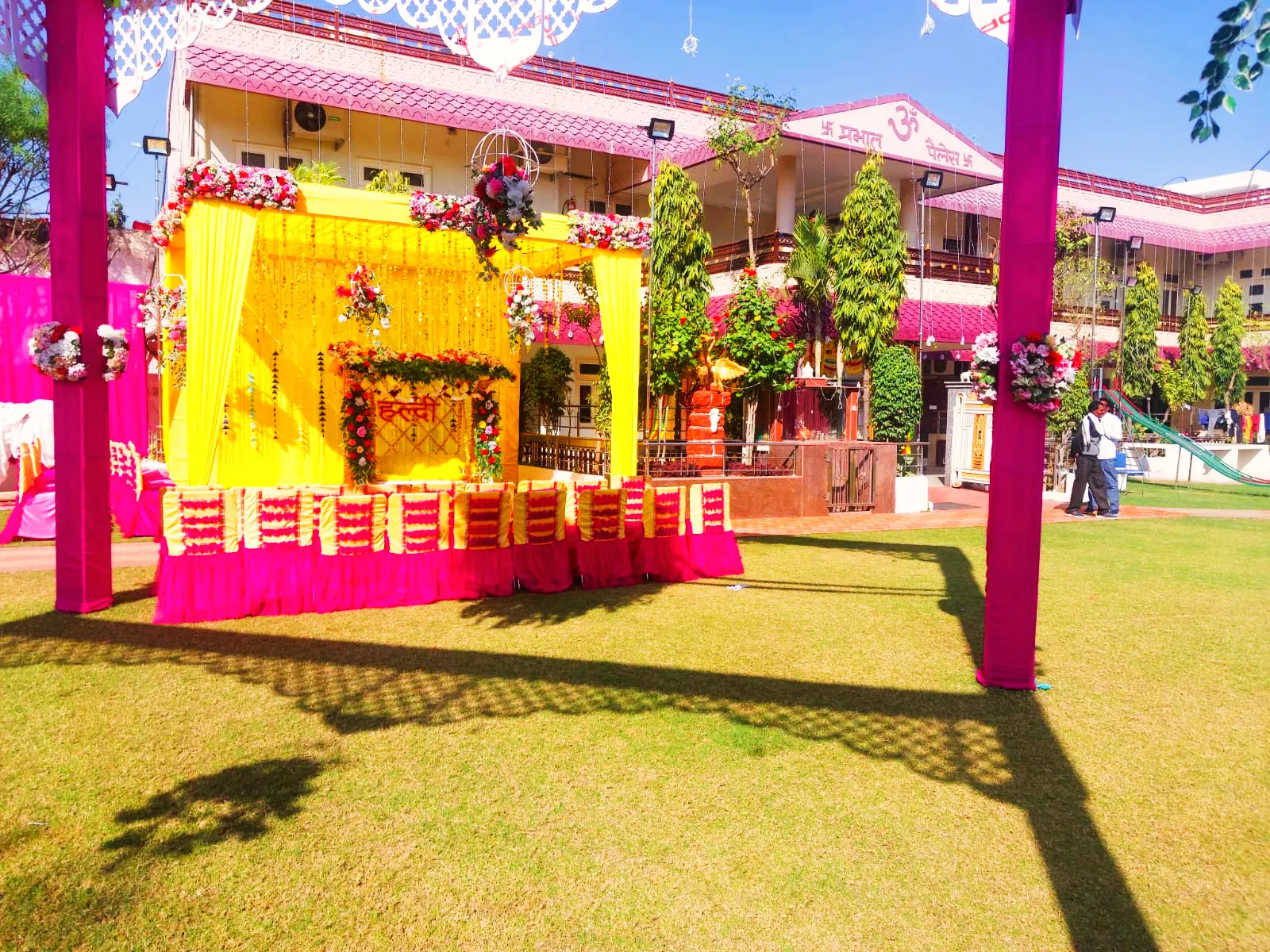 A bright haldi setup on the garden in daylight.