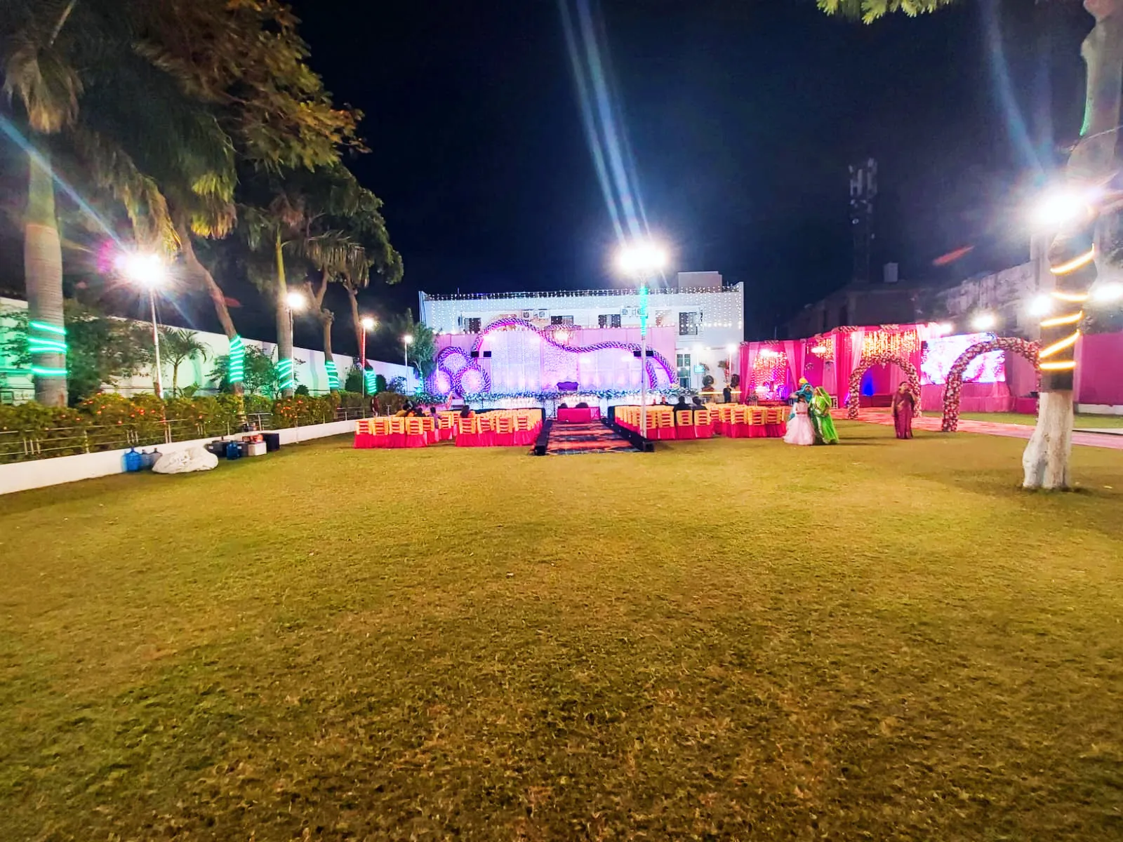 The garden glowing with lights for a wedding evening.